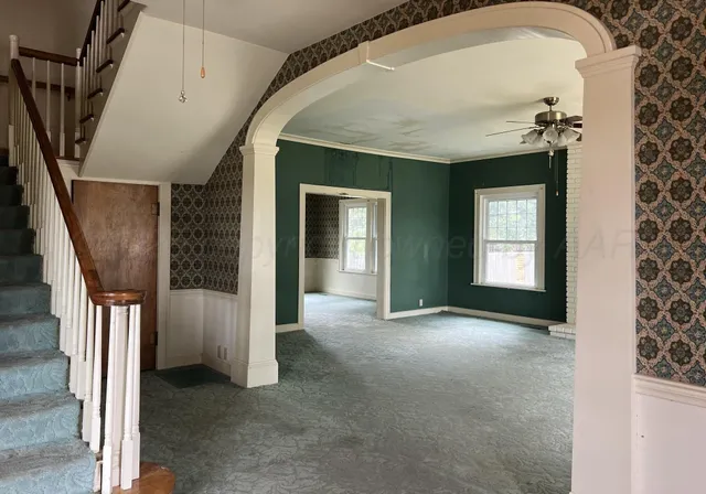 a view of a livingroom with a fireplace and window