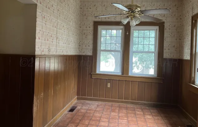 a view of staircase with railing and white walls