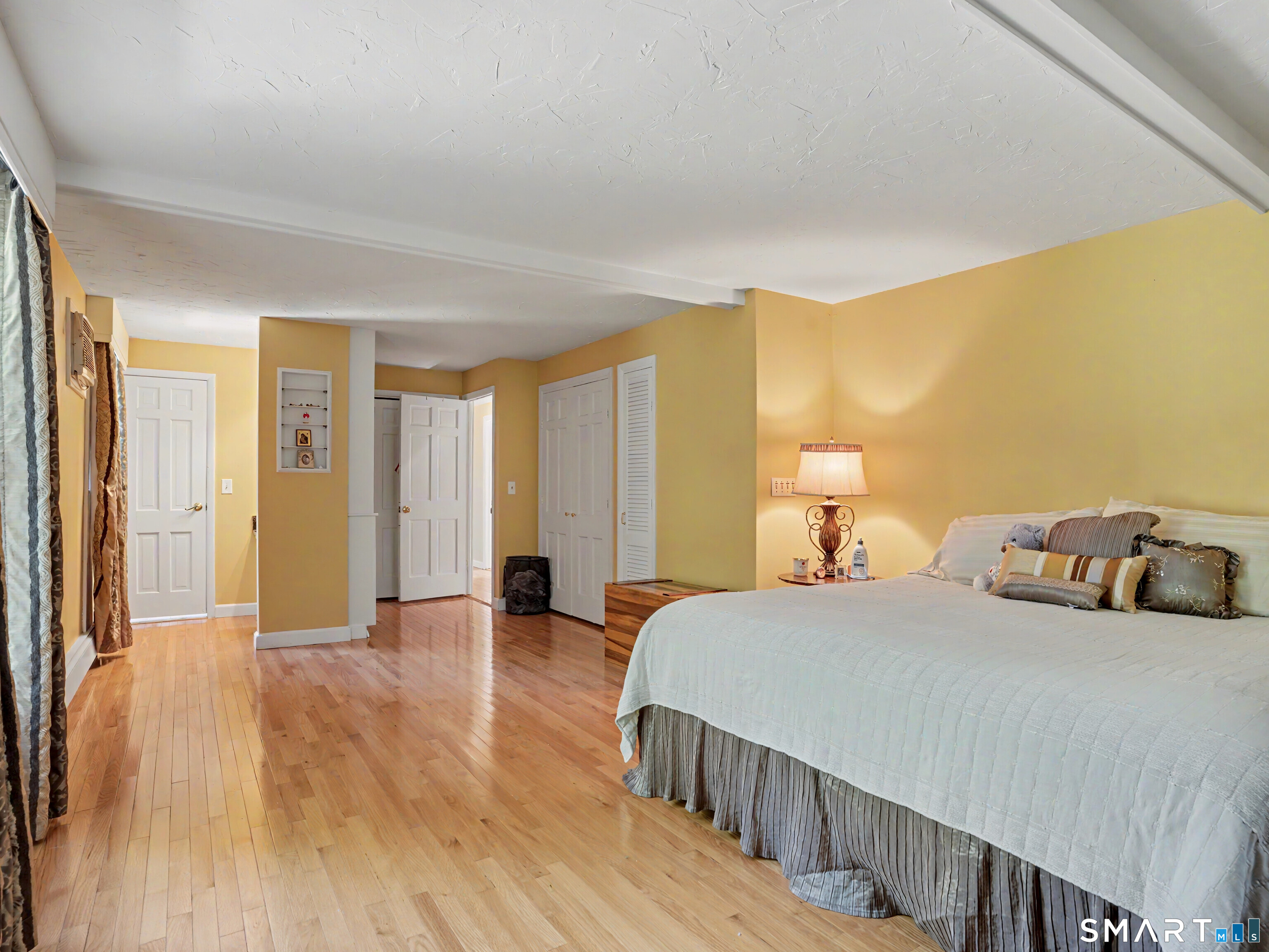 15 Flat Rock Drive Ridgefield, CT 06877 - Photo 27 of 39 a bedroom with a bed and wooden floor