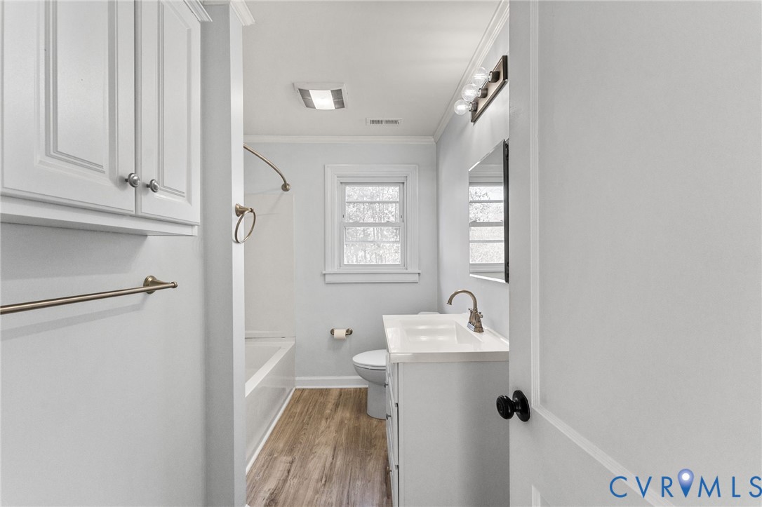 352 3rd Street Emporia, VA 23847 - Photo 15 of 25 a bathroom with a sink a mirror and a toilet