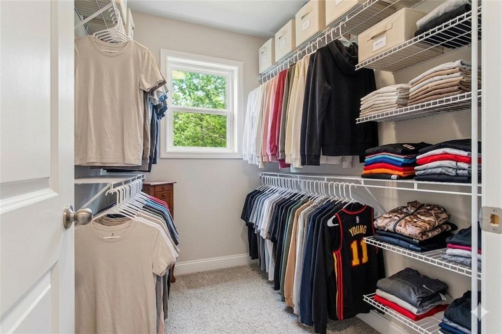 171 Strickland Loop Forsyth, GA 31029 - Photo 15 of 25 a view of walk in closet with clothes and shoes