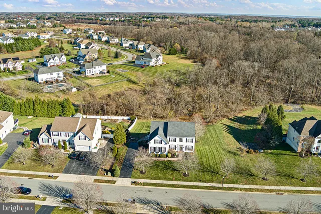 a large kitchen with stainless steel appliances granite countertop a large stove a sink dishwasher and a refrigerator with wooden floor