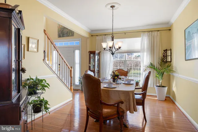 a living room with a bed dresser and a mirror