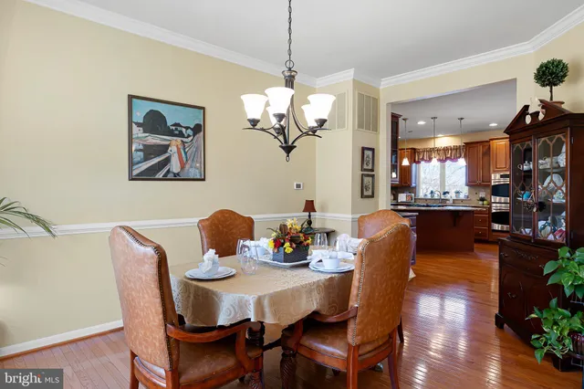 a bedroom with a bed chandelier and a window