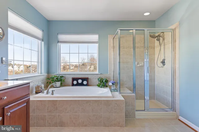 a bathroom with a granite countertop toilet a sink and a mirror