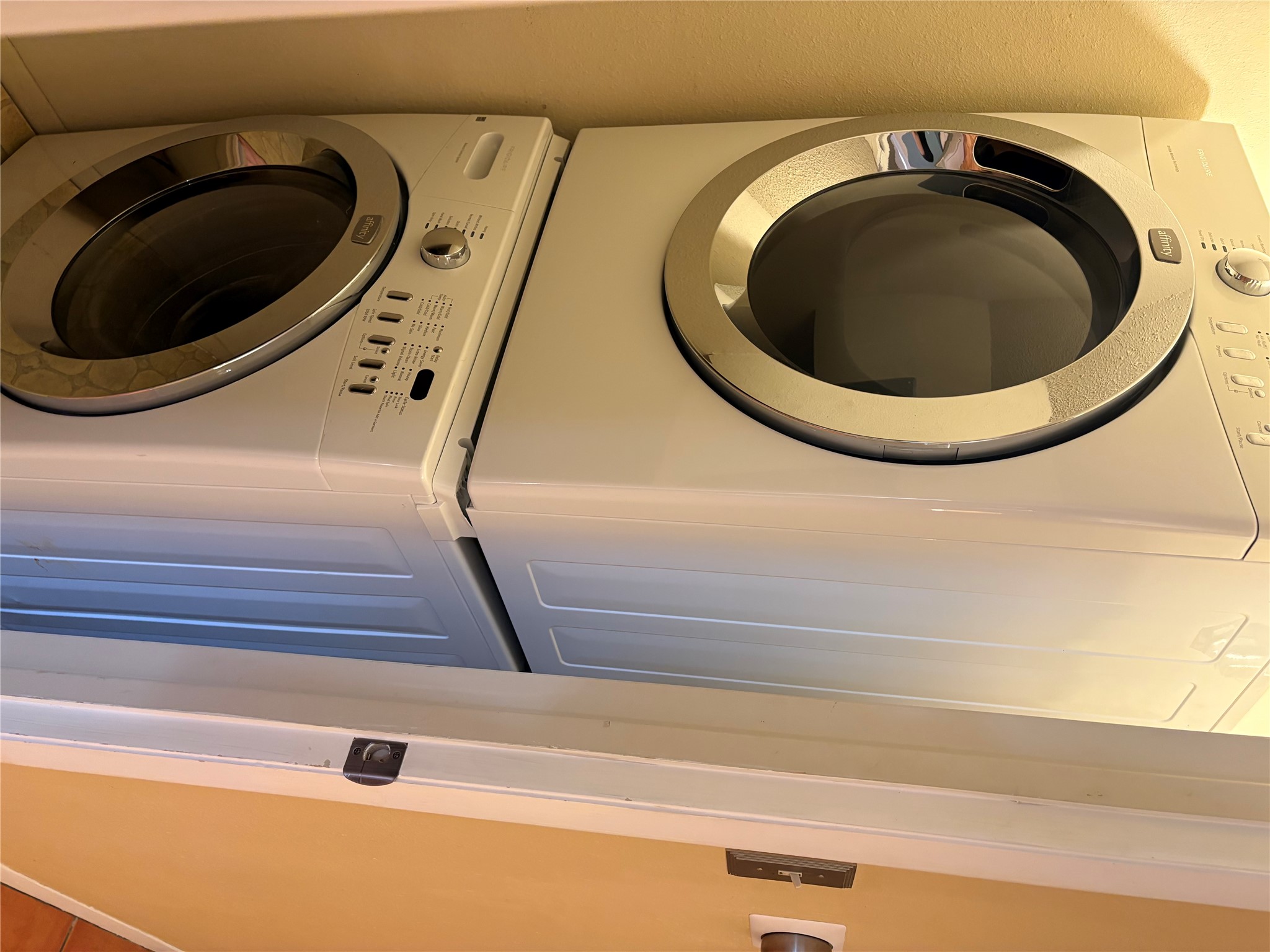 9226 Jollyville Road, Unit 144 Austin, TX 78759 - Photo 13 of 40 Laundry area featuring stacked washer and clothes dryer - in halway with a door to close off for privacy