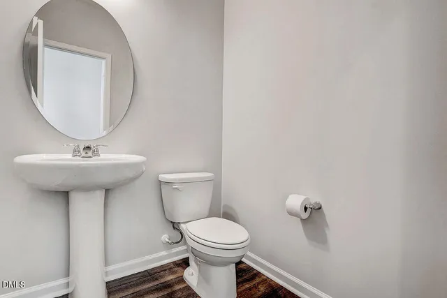 a bathroom with a sink toilet and a mirror