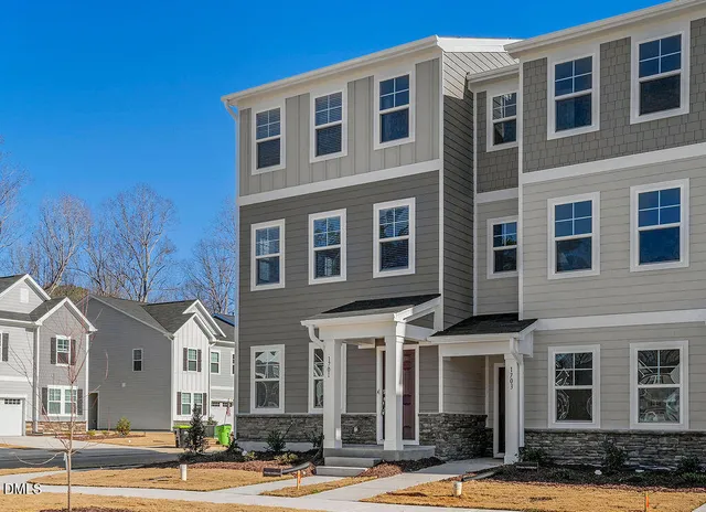 a front view of a building with a yard