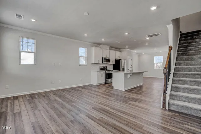 a view of kitchen with cabinets and wooden floor