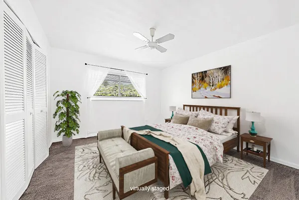 a bedroom with a bed and a painting on the wall