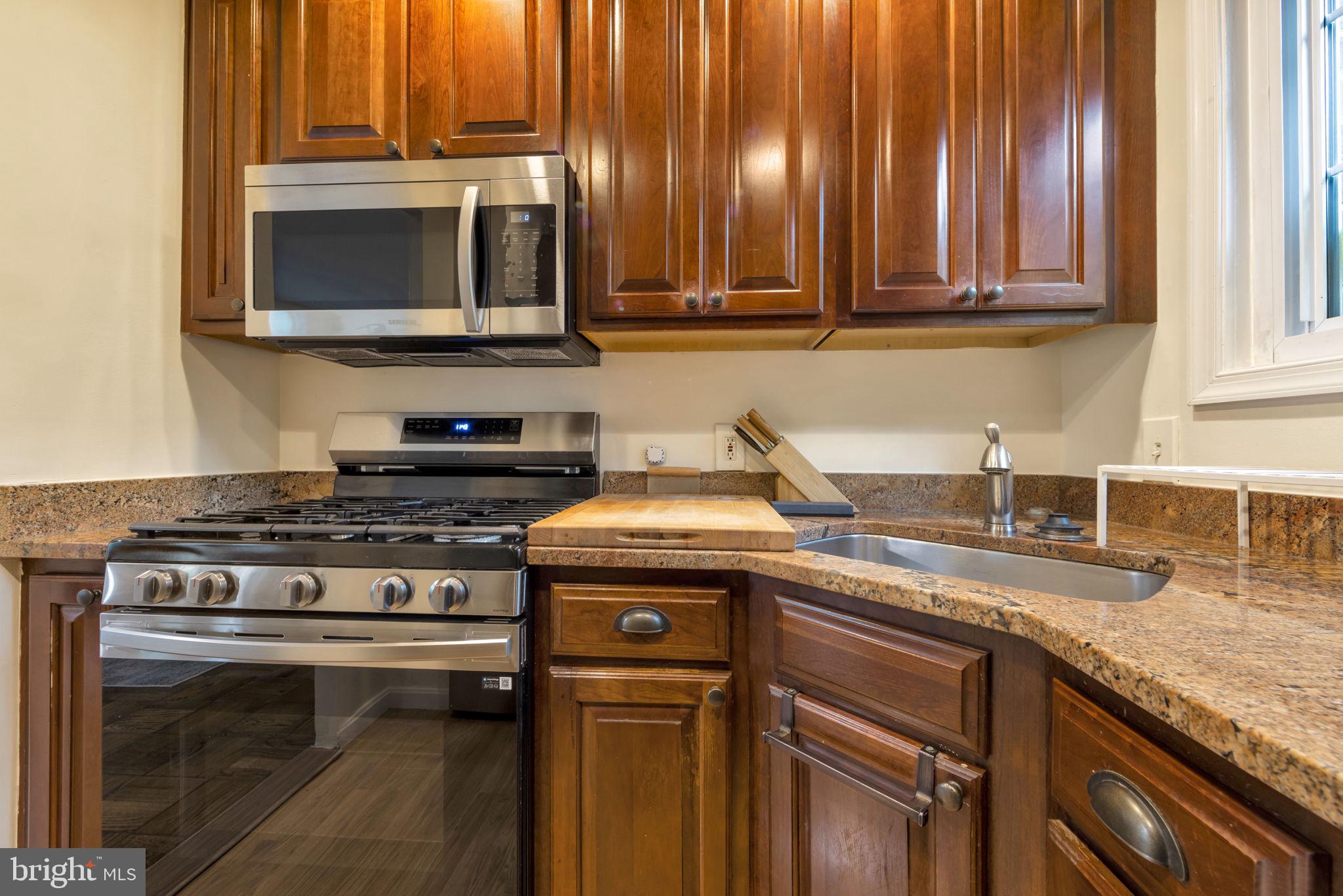 3400 Gunston Road Alexandria, VA 22302 - Photo 7 of 15 Modern kitchen with rich wood accents.