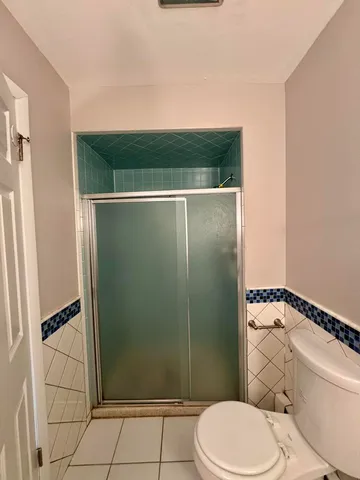 a bathroom with a toilet and a shower