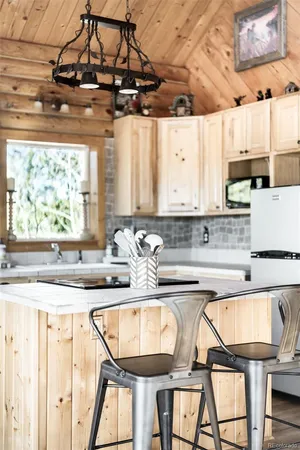 a kitchen with a table chairs stove and cabinets