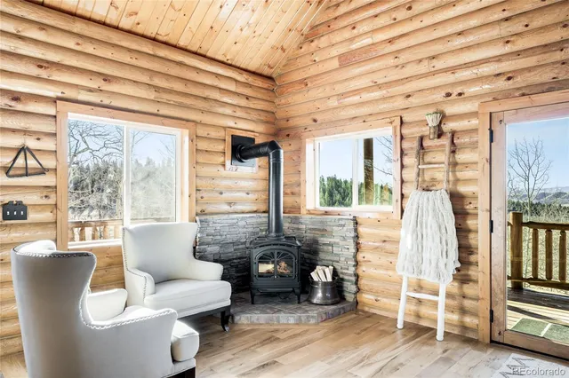 a living room with furniture and large windows