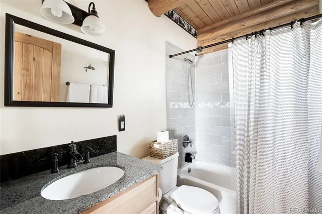 a bathroom with a granite countertop sink mirror and a bathtub