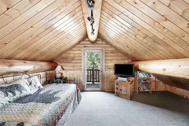 a bedroom with furniture and a flat screen tv