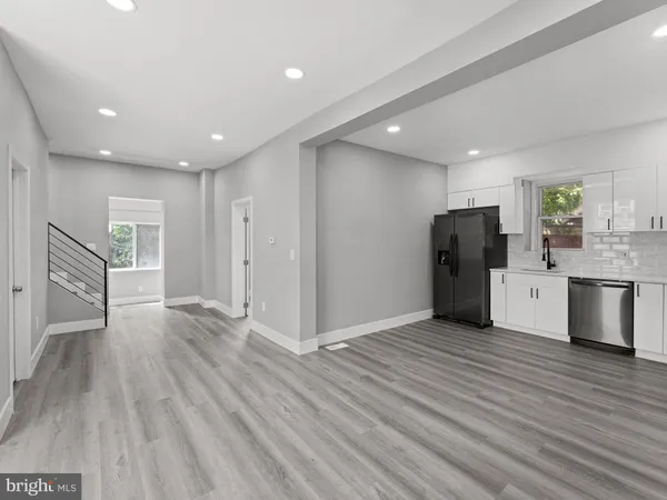 a view of kitchen with refrigerator microwave and cabinets