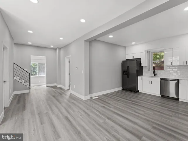 a view of kitchen with refrigerator microwave and cabinets