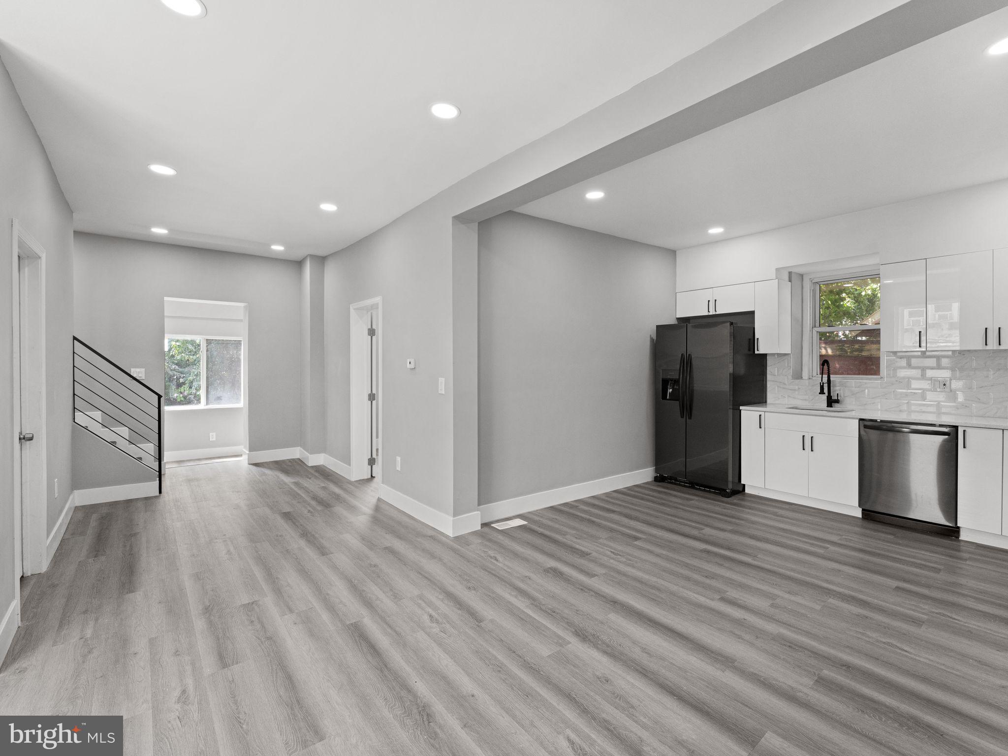 a view of kitchen with refrigerator microwave and cabinets