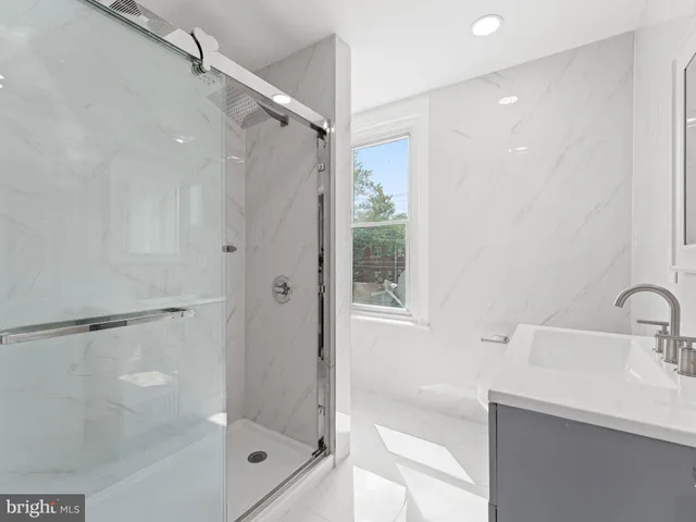 a bathroom with a shower and a sink