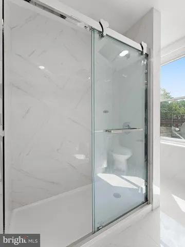 a bathroom with a glass shower door