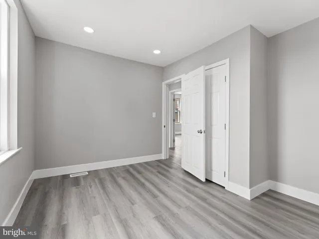 a view of room with window and wooden floor
