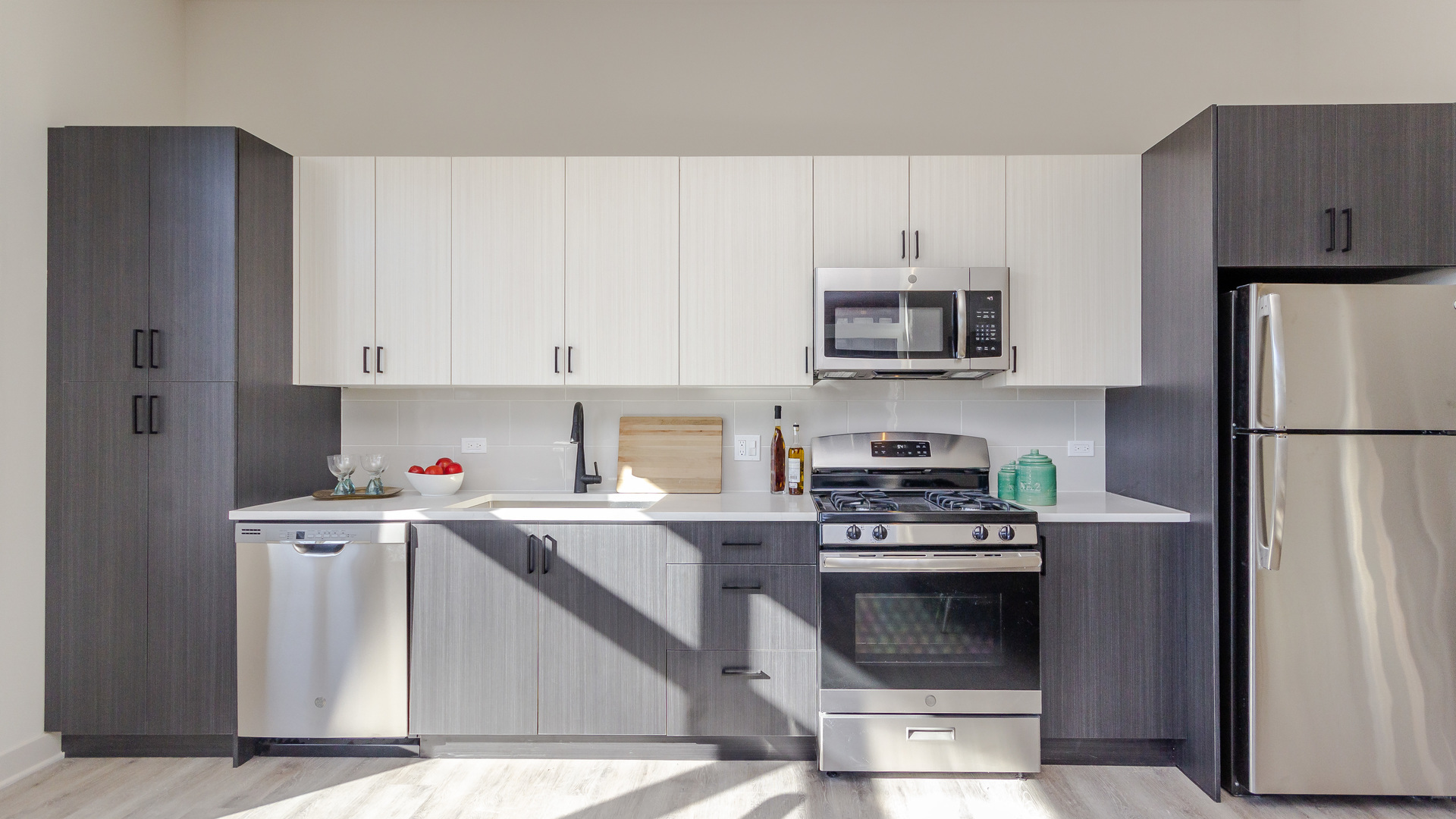 1502 West Ainslie Street, Unit 208 Chicago, IL 60640 - Photo 5 of 5 a kitchen with granite countertop wooden cabinets and stainless steel appliances
