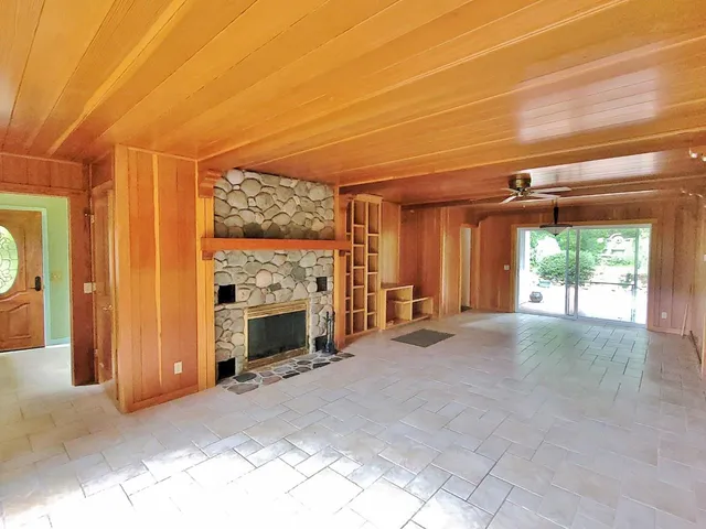wooden floor in an empty room with a window