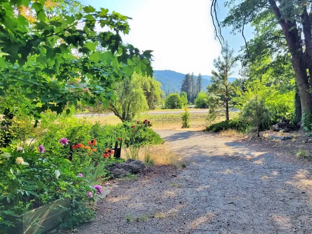 a view of an empty room with a fireplace and a window