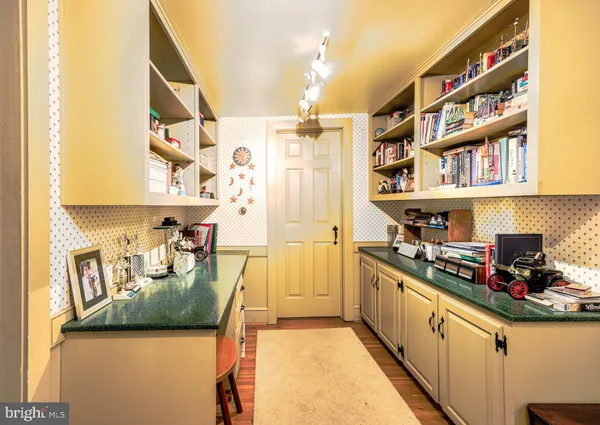 a kitchen with stainless steel appliances granite countertop a lot of cabinets