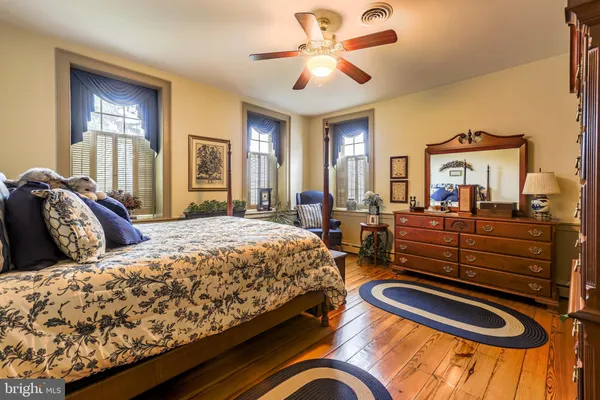 a bedroom with a bed and ceiling fan