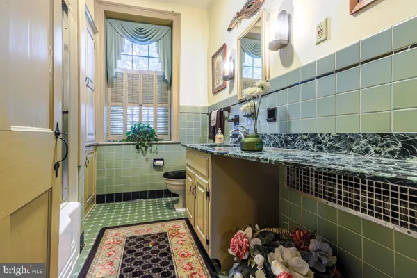 a bathroom with a sink a mirror and shower