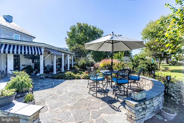 a view of a chair and table in the patio with a fire pit