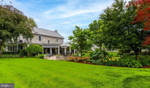 a view of a house with a backyard porch and sitting area