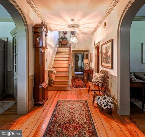 a very nice looking room with wooden floor and furniture