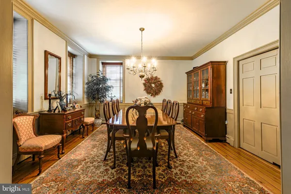 a dining room with furniture a chandelier and window