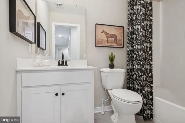 a bathroom with a toilet a sink and a mirror