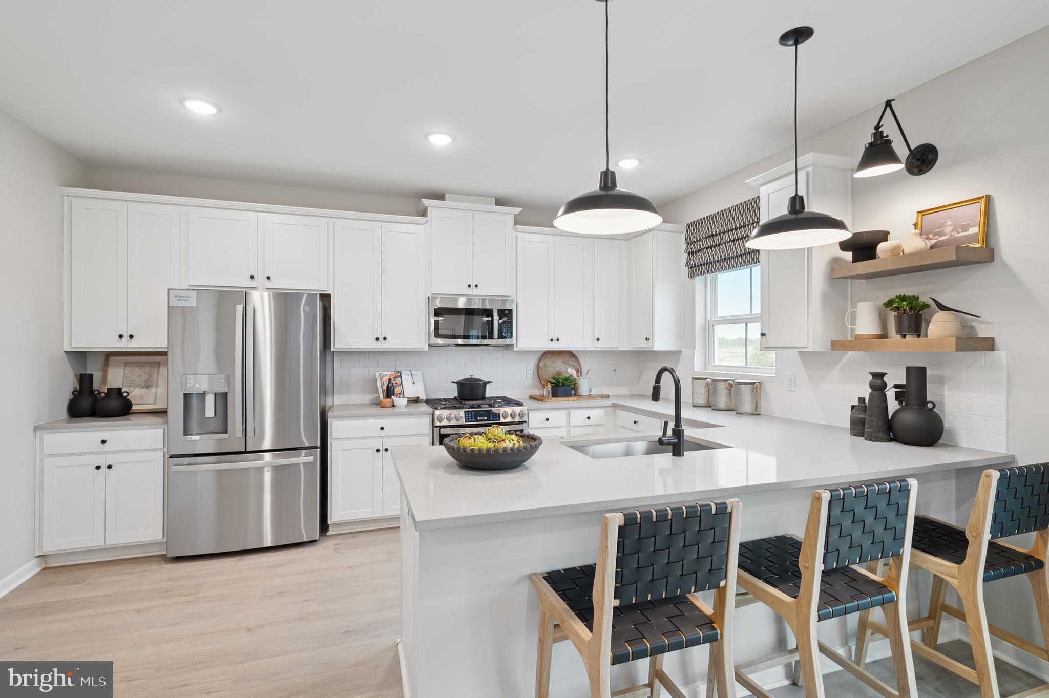 63 Sweetgum Road, Unit 35 Berlin, NJ 08009 - Photo 7 of 38 a kitchen with a refrigerator a stove a sink and chairs