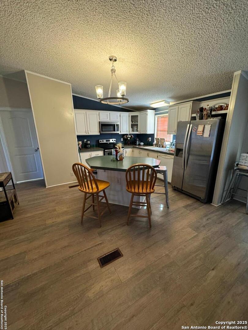 606 North Main Street Cotulla, TX 78014 - Photo 5 of 14 a view of a dining room with furniture and a wooden floor