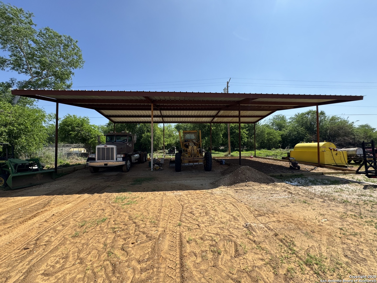 606 North Main Street Cotulla, TX 78014 - Photo 6 of 14 a view of a patio with a table and chairs under an umbrella