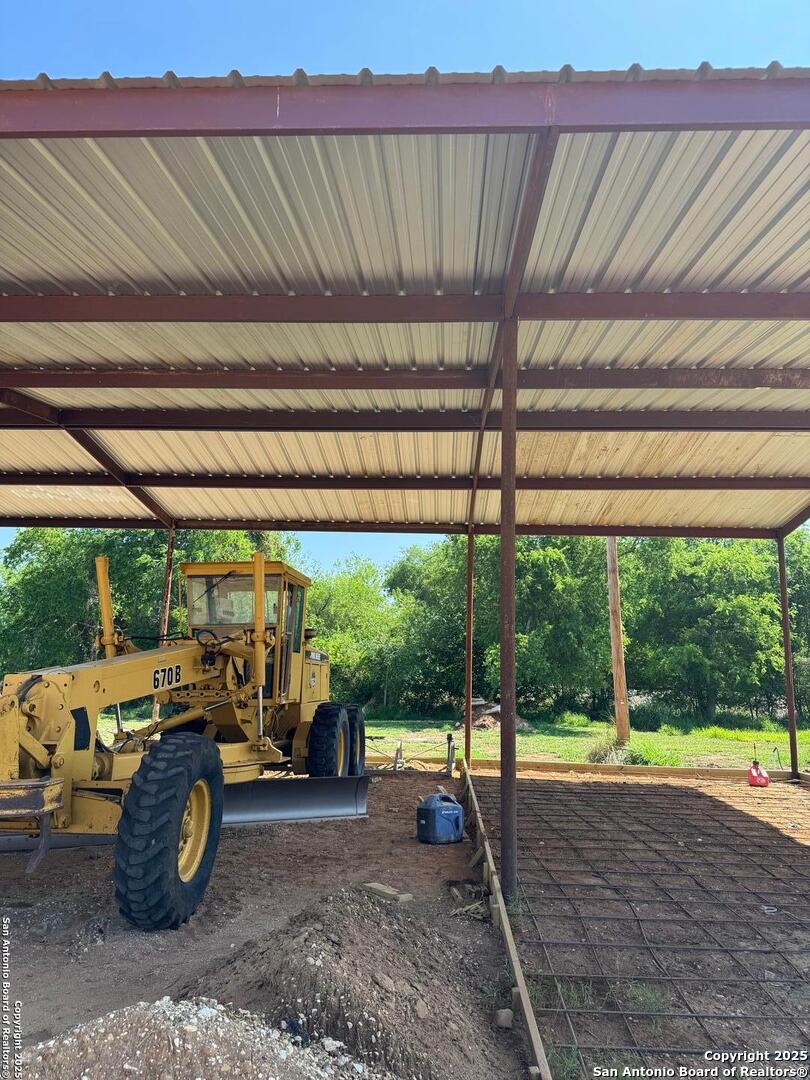 606 North Main Street Cotulla, TX 78014 - Photo 7 of 14 a view of a patio with table and chairs under an umbrella