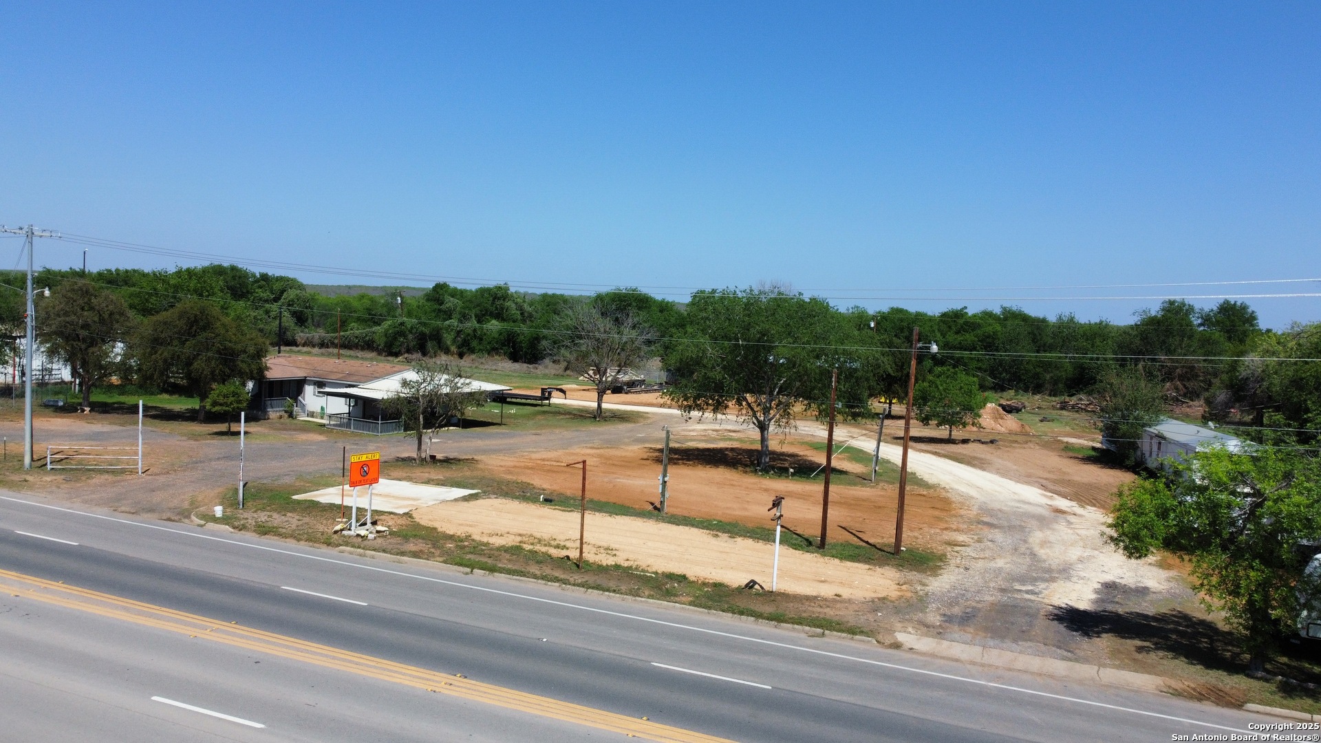 606 North Main Street Cotulla, TX 78014 - Photo 10 of 14 a view of a swimming pool with lounge chairs in patio