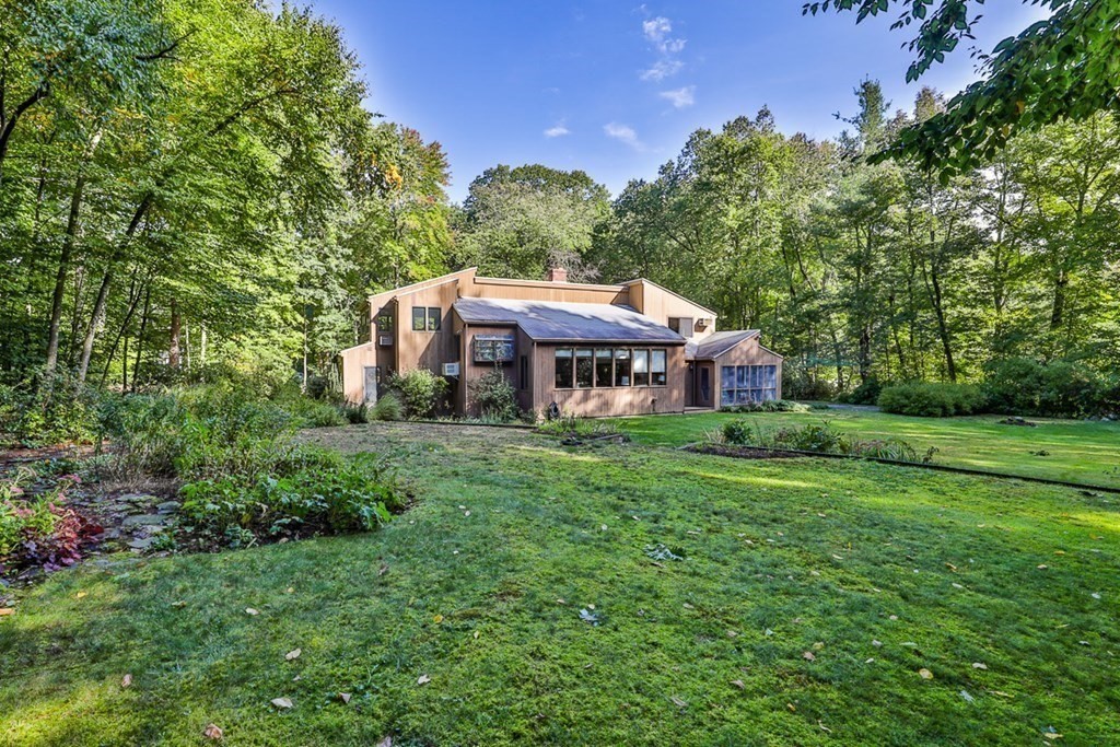 121 West Bare Hill Road Harvard, MA 01451 - Photo 1 of 36 a view of a house with a big yard plants and large trees