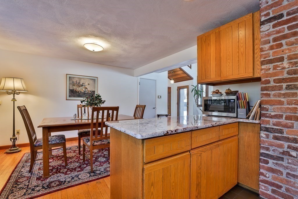 121 West Bare Hill Road Harvard, MA 01451 - Photo 11 of 36 a kitchen with stainless steel appliances granite countertop a sink and cabinets
