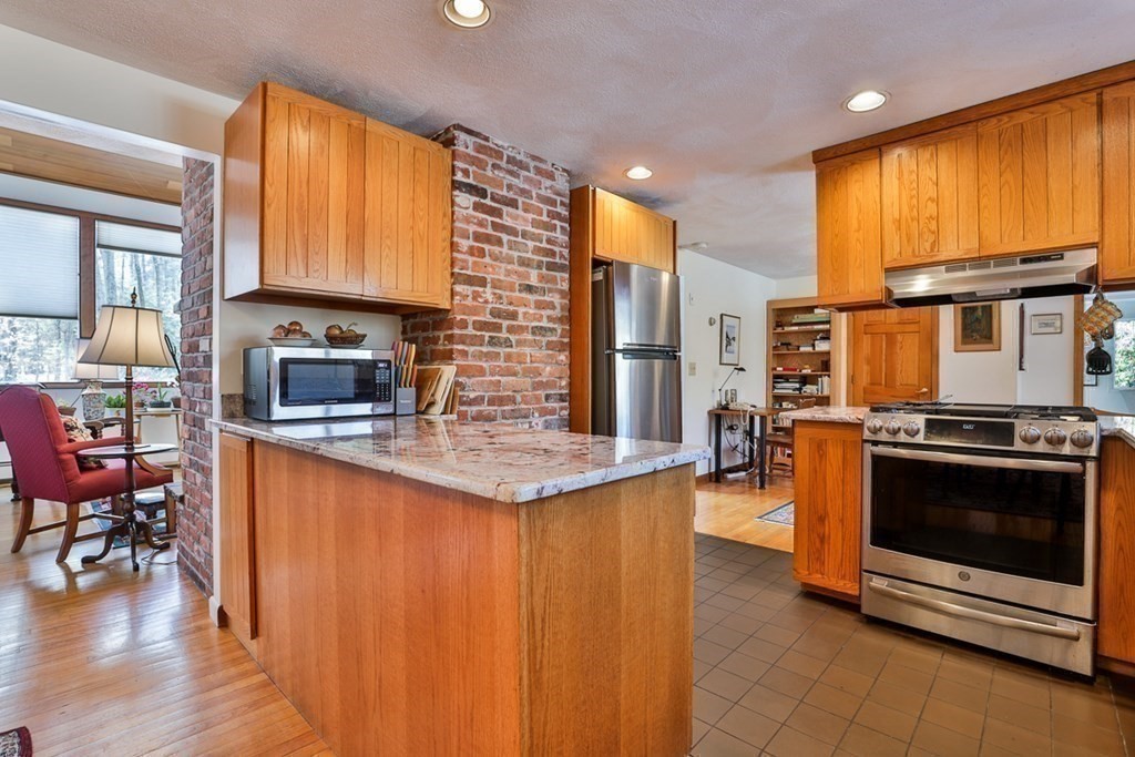 121 West Bare Hill Road Harvard, MA 01451 - Photo 13 of 36 a kitchen with stainless steel appliances granite countertop a stove a sink and a microwave
