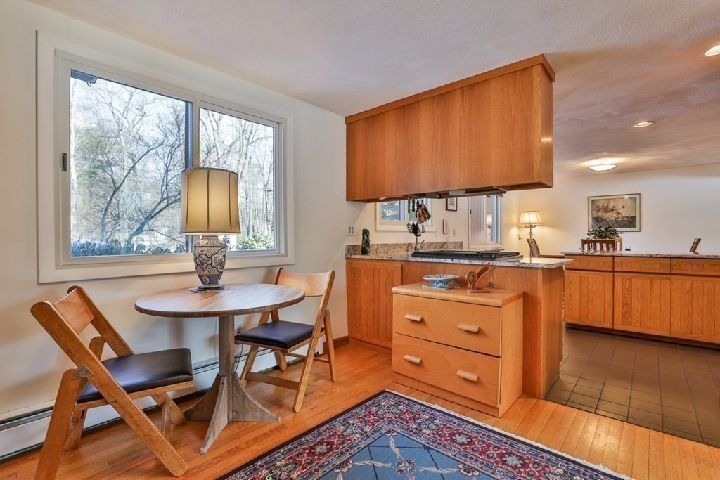 121 West Bare Hill Road Harvard, MA 01451 - Photo 14 of 36 a room with a chair a computers on the table and a flat screen tv