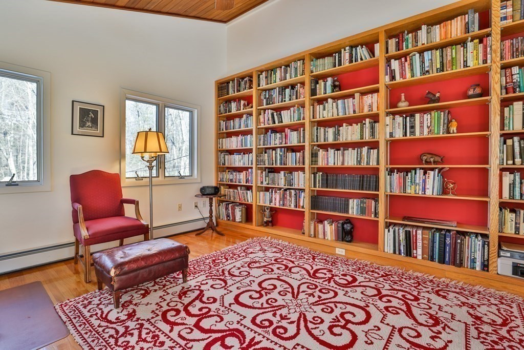 121 West Bare Hill Road Harvard, MA 01451 - Photo 22 of 36 a living room with fireplace furniture and a book shelf
