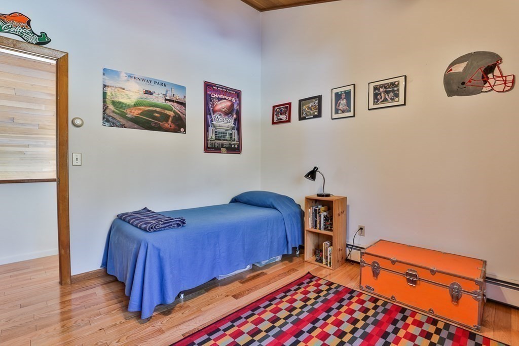 121 West Bare Hill Road Harvard, MA 01451 - Photo 25 of 36 a bedroom with a bed and wooden floor