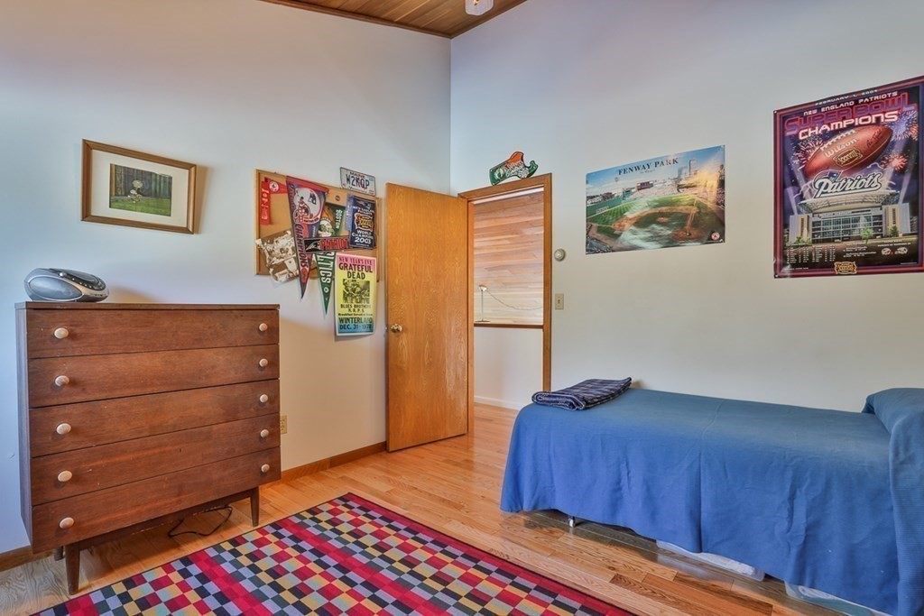 121 West Bare Hill Road Harvard, MA 01451 - Photo 26 of 36 a bedroom with a bed and wooden floor
