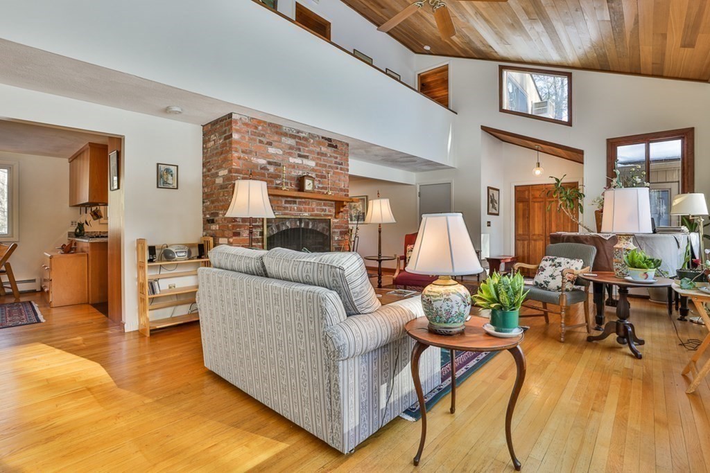 121 West Bare Hill Road Harvard, MA 01451 - Photo 3 of 36 a living room with furniture and a chandelier